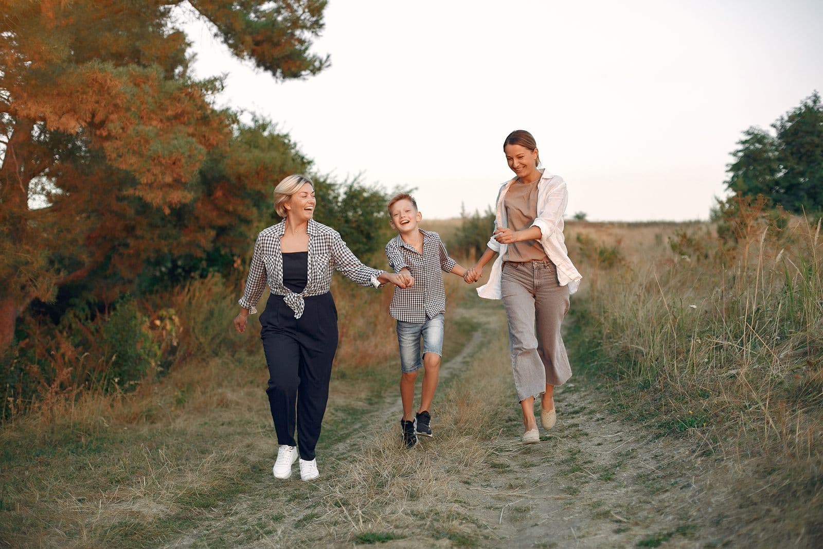 A multigenerational family walking together at golden hour